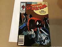 Front cover photo showing Spider-Man with a graveyard background and text "Who Kidnapped Mary Jane?"