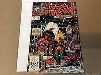Front cover of The Amazing Spider-Man #314 comic book showing Spider-Man with a woman and a large figure in a winter city scene.