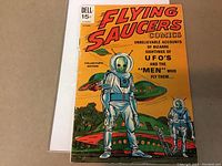 Photo of front cover showing title Flying Saucers Comics, issue #2, 1969, featuring humanoid aliens and flying saucers.