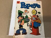 Photo showing the front cover of the Popeye comic, issue #24 from 1953 with colorful cartoon art and Dell logo.