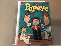 Front cover photo of Popeye comic book issue #29 showing Popeye and Olive Oyl on a ship, with visible wear on spine.
