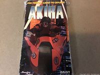 Front of the Akira VHS tape package showing character on motorcycle and main title.