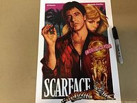 Full view of the Scarface art print with a Sharpie pen included for scale, showing the colors, characters, and text details