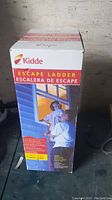 Box of Kidde escape ladder showing product image and bilingual description highlighting 2 story, 13 ft ladder