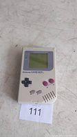 Front view of Nintendo Game Boy showing screen, directional pad, and buttons.