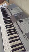Close-up view of the Yamaha PSR-E403 keyboard showing white and black keys and control buttons