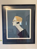 Full view of the framed art print showing the female profile in side view illustration with black frame.
