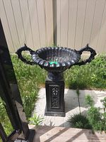 Front view of the urn on its pedestal showing overall design and condition