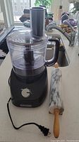 Black and Decker food processor on countertop with marble rolling pin to the side