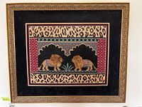Full framed needlepoint with two lions facing each other within patterned borders and leopard print matting.