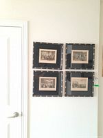 Four framed prints by T. Allom arranged in a 2x2 grid on white wall. Each frame contains a detailed architectural or cityscape black and white print with black mat featuring gold star accents.