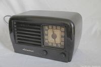 Front view of black Admiral AM tube radio showing tuning dial and control knobs.