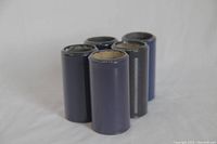 Five Blue Amberol Edison phonograph cylinders standing upright, showing condition and color.