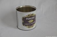 Angled side view of the Perkins Tobacco Mixture tin showing the label in good condition.