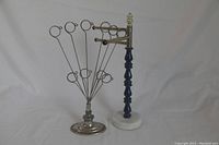 Full view of photo holder with spiral clips and jewellery holder with navy handle and marble base.