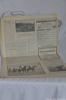 Full view of an inside page showing black and white advertisements and articles, text and images from the early 1900s