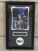 Custom framed signed photo of Gene Simmons in black frame with name plaque and KISS logo