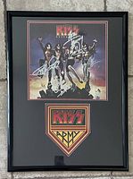 Full image of the framed KISS album cover and mounted logo