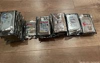 Multiple stacks of assorted internal hard drives in anti-static bags, labeled with storage capacities and brand information visible.