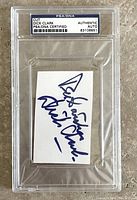 Front view of the Dick Clark signed cut card inside PSA/DNA certified plastic holder showing the autograph clearly.