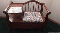Frontal view of bench with floral cushion and left-side shelf