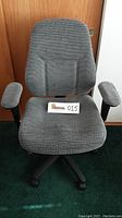 Front view of the gray upholstered task chair showing padded armrests, contoured seat and back, and five-wheel base.