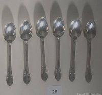 Photo showing all six demitasse spoons arranged side by side, showing the full set and the shape of the spoons.