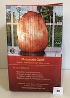 Frontal image of sealed Mountain Gold Himalayan Salt Lamp box showing product image and benefits.