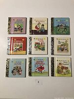 Photo of 9 Little Golden Books on white background, titles visible including Animals of Farmer Jones, We Help Mommy, The Three Little Pigs.