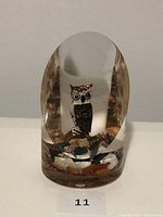 Front view of the vintage owl in resin, showing the detailed hand carved and painted owl encased in clear resin with rocky base details.