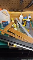 Wide view of lot showing various glue bottles, wooden and metal rulers, measuring tools and more.