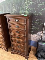 Front view of the chest showing seven drawers and brass handles