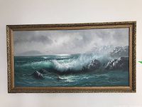 Full front view of painting in ornate gold frame hung on white wall