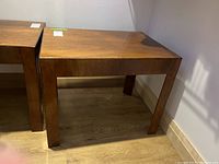 Side view of the wood side table showing straight legs and wood grain finish.