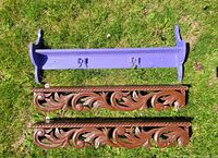 Purple princess wooden shelf painted in purple with three butterfly-shaped hooks on front, placed on grass outdoors.