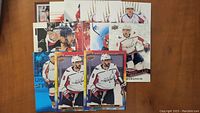 Fifteen assorted Alex Ovechkin hockey cards, featuring various designs and poses in Washington Capitals white jersey.