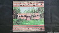 Front cover of the vinyl album showing the abandoned luncheonette building and the Hall and Oates title.