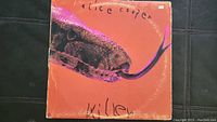 Photo of Alice Cooper Killer vinyl album front cover showing orange background and snake image.