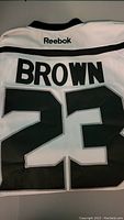 Back view showing the name BROWN and number 23 with Reebok branding at collar