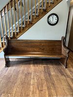 Front view of antique church pew showing overall condition and finish.
