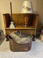 Photo showing oak hall bench, homemade wood lamp, copper box, and antique vacuum washer in room setting