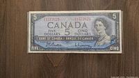 Front side of the 1954 Canadian five dollar bill showing Queen Elizabeth II, serial number, and denomination details.