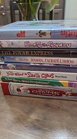 Stack of eight Christmas DVDs showing titles and spines