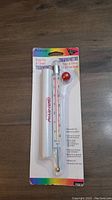 Photo of the AccuTemp Deep Fry & Candy Thermometer in its original packaging showing product details and features.