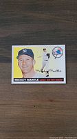 Front of the 2011 Mickey Mantle insert baseball card showing color images of Mantle in New York Yankees uniform along with the Yankees logo.