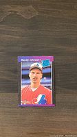 Front view of the Randy Johnson rookie card showing the player in Montreal Expos uniform with purple border and Rookie label.