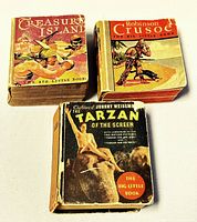 Three vintage children's books from 'The Big Little Book' series: Treasure Island, Robinson Crusoe, Tarzan, showing front covers and spine wear.