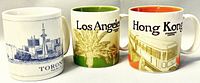 Three Starbucks mugs showing Toronto, Los Angeles, and Hong Kong city themes side-by-side with interiors visible to show color differences