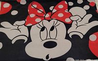 Close-up front view of the Minnie Mouse printed design on the towel, showing the red bow with white polka dots and Minnie’s face.