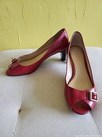 Side profile view of red Ralph Lauren open-toe heel showing buckle and heel shape.